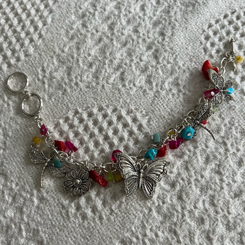 Silver charm bracelet with colored beads and silver with black charms